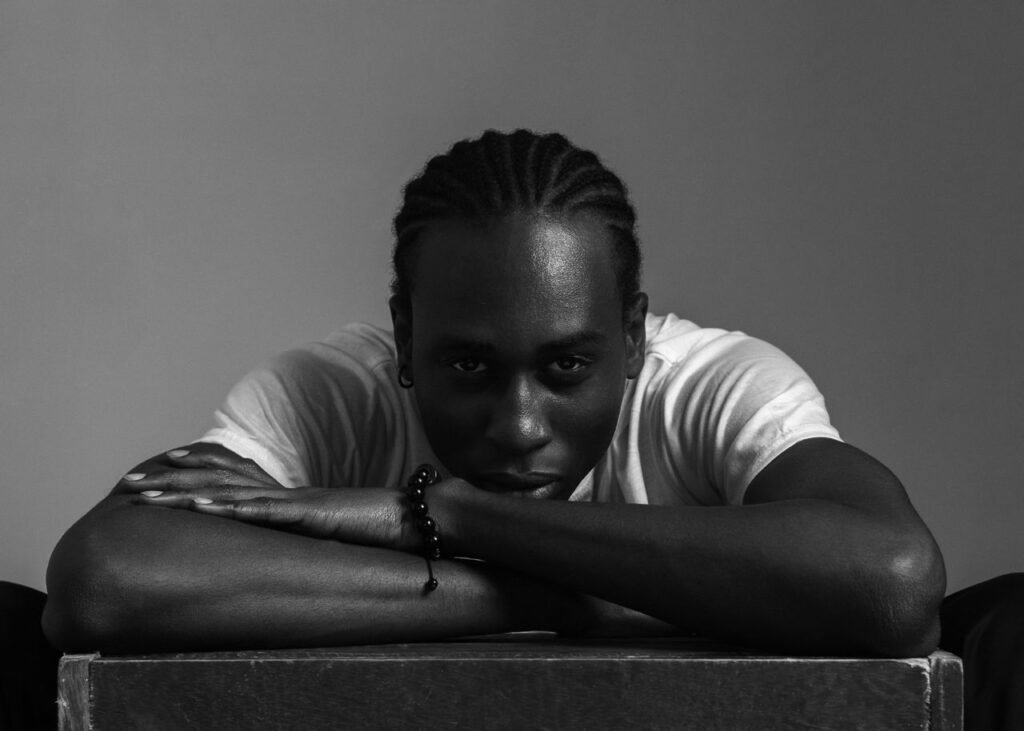 Striking black and white portrait of a contemplative individual in Ibadan, Nigeria.