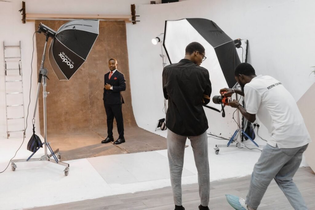 A professional photography session in a modern studio with photographer and subject.